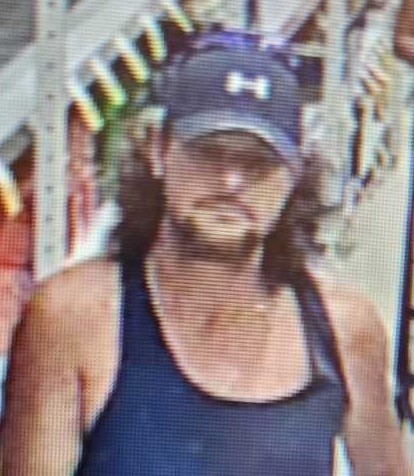 photo of male suspect in ball cap and tank top